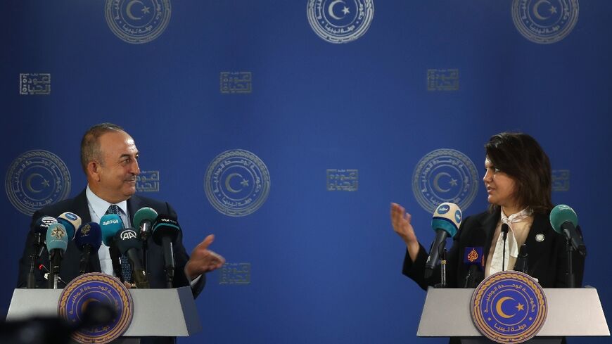 Libyan Foreign Minister Najla al-Mangoush and Turkish Foreign Minister Mevlut Cavusoglu speak to reporters after s signing a maritime gas deal