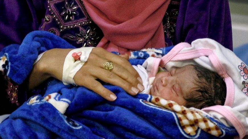 A mother and her newborn baby at the UNFPA-supported Sexual and Reproductive Health (SRH) clinic in the Zaatari camp for Syrian refugees 