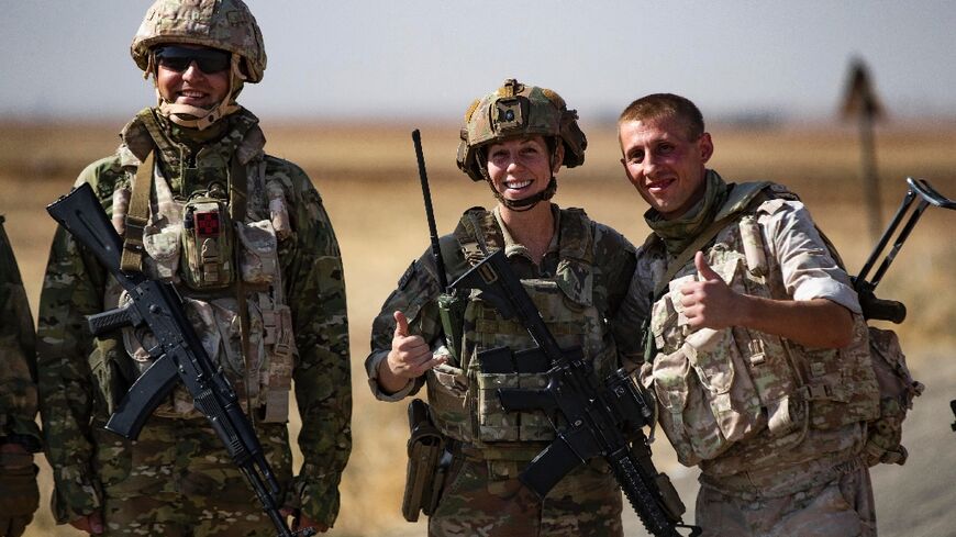 Rival Russian and US soldiers stood side by side as they spoke and posed for pictures