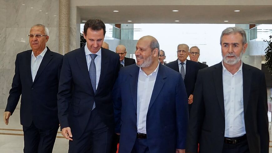 Syria's President Bashar al-Assad (2-L) receives the leader of Islamic Jihad, Ziad al-Nakhala (R), Hamas chief of Arab relations, Khalil al-Hayya (2-R) and secretary general of the Popular Front for the Liberation of Palestine, Talal Naji (L), in Damascus