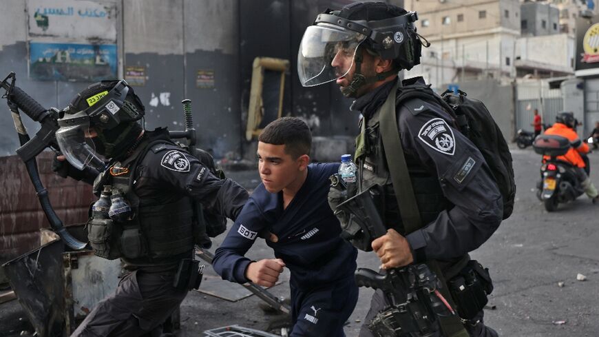 Israeli security forces arrest a young Palestinian protester during confrontations in the Shuafat refugee camp in Israeli-annexed east Jerusalem