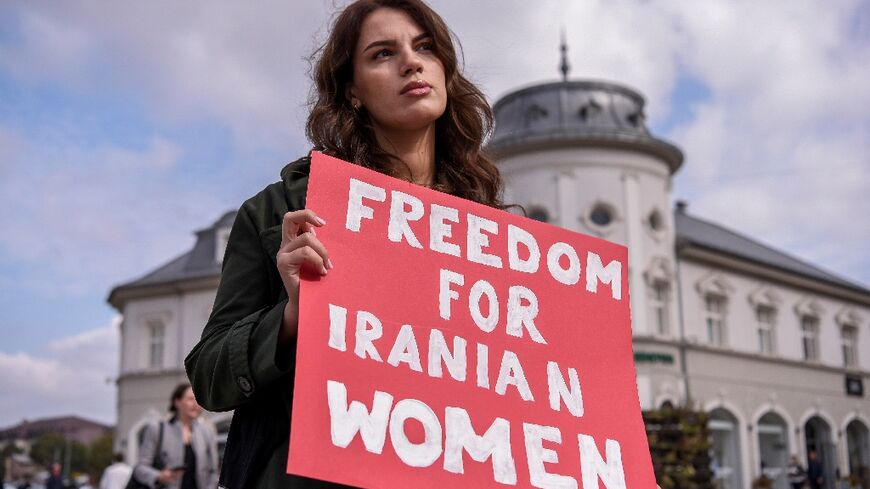 A woman takes part in a rally in support of Iranian women in Pristina on October 12, 2022