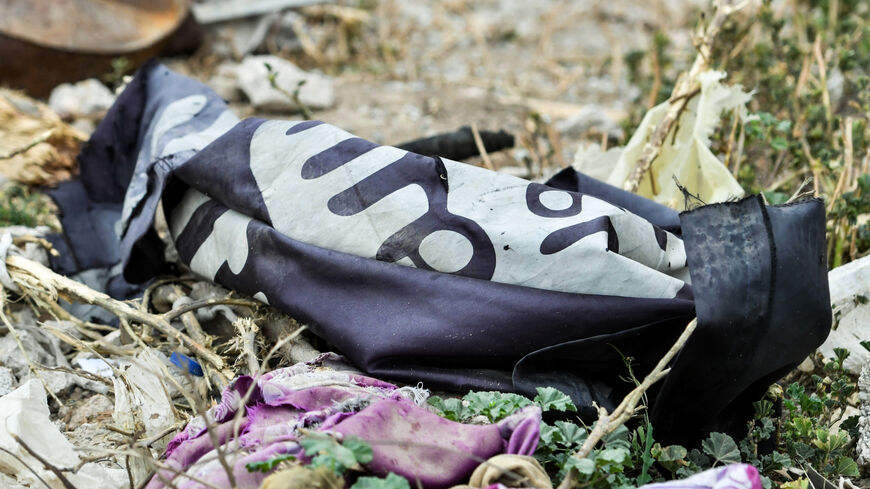 This picture taken on March 24, 2019, shows a discarded Islamic State flag.