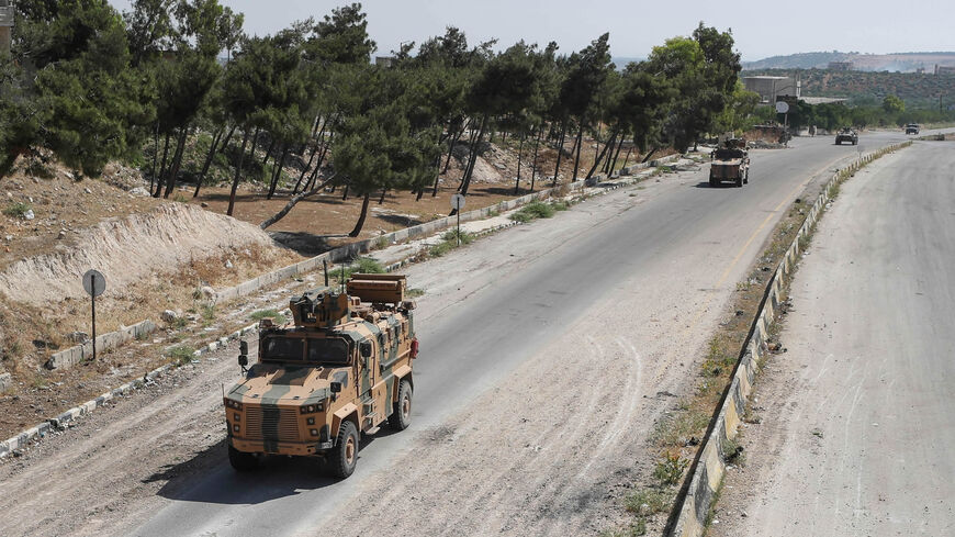 Military vehicles of a joint Russian-Turkish patrol pass through the M4 highway, which links the northern Syrian provinces of Aleppo and Latakia, near Ariha in the rebel-held northwestern Idlib province, Syria, June 10, 2020.