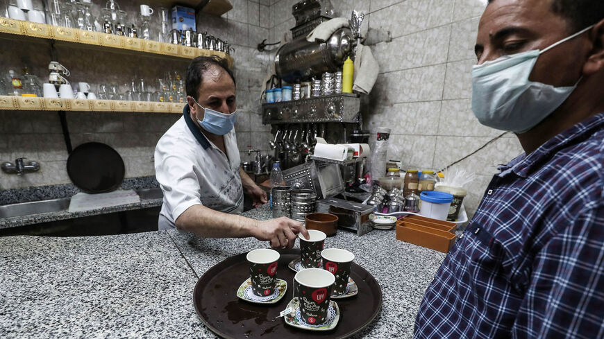 A worker prepares an order at a cafe after authorities relaxed the coronavirus lockdown measures, Cairo, Egypt, June 27, 2020.