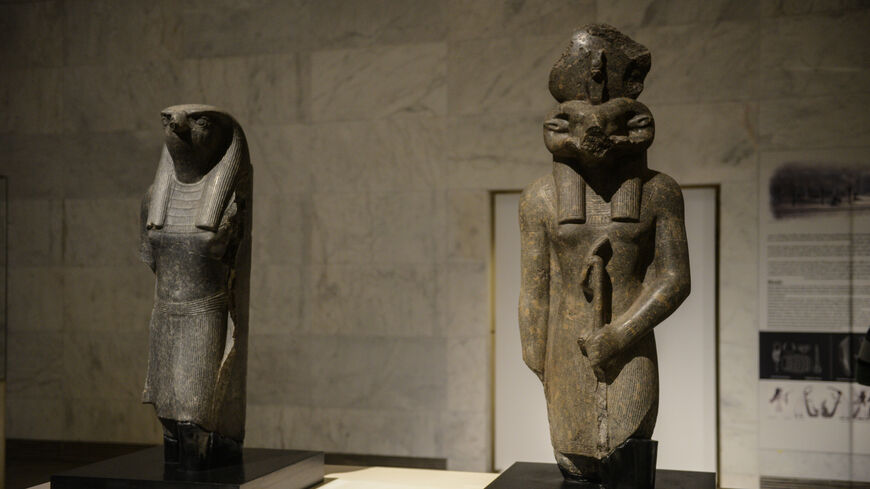 Statues of Pharaonic Gods Horus and Khnum are displayed at the museum on April 4, 2021, in Cairo, Egypt. 