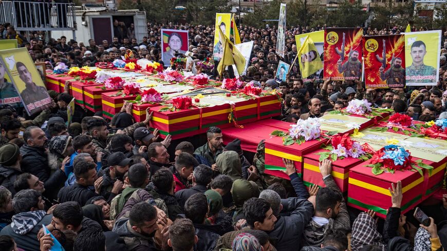 People take part in a funeral in the Kurdish-majority city of Qamishli in Syria's northeastern Hasakah province.