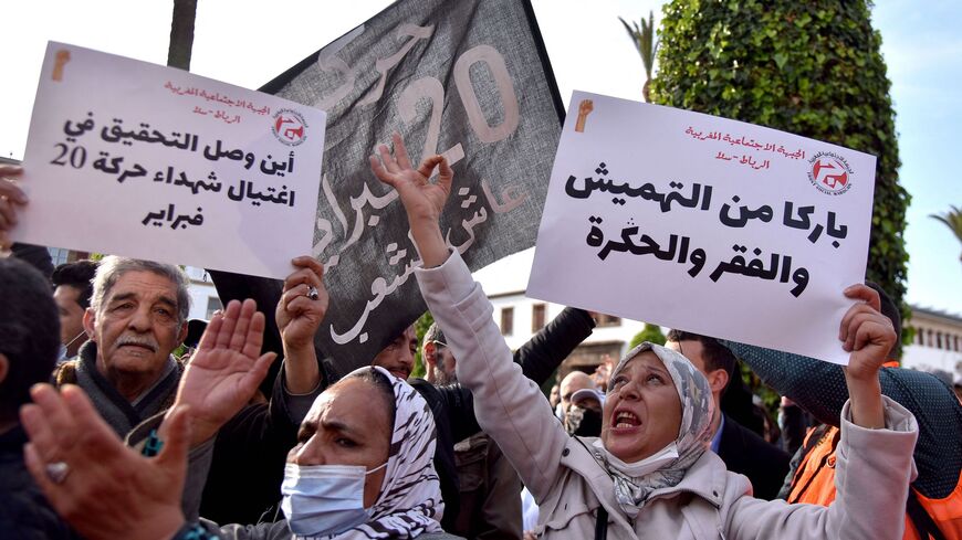 Moroccans raise placards as they gather in front of parliament in the capital Rabat to protest against rising prices, on February 20, 2022. (Photo by AFP) (Photo by STR/AFP via Getty Images)