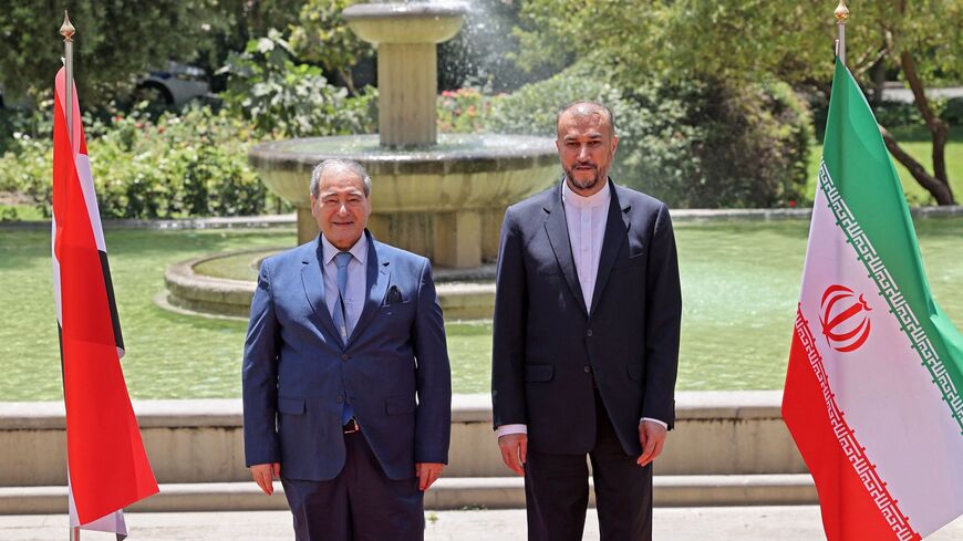 Iran's Foreign Minister Hossein Amir-Abdollahian (R) receives his Syrian counterpart Faisal Mekdad in Tehran, on July 20, 2022.