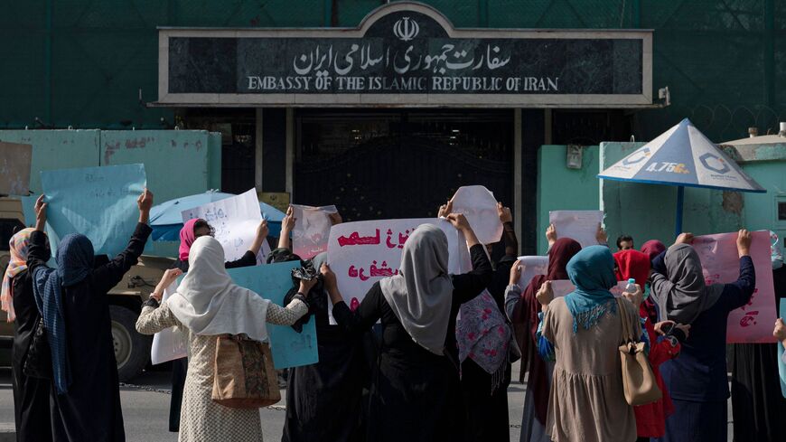 Afghan women hold placards as they take part in a protest in front of the Iranian Embassy in Kabul on Sept. 29, 2022.