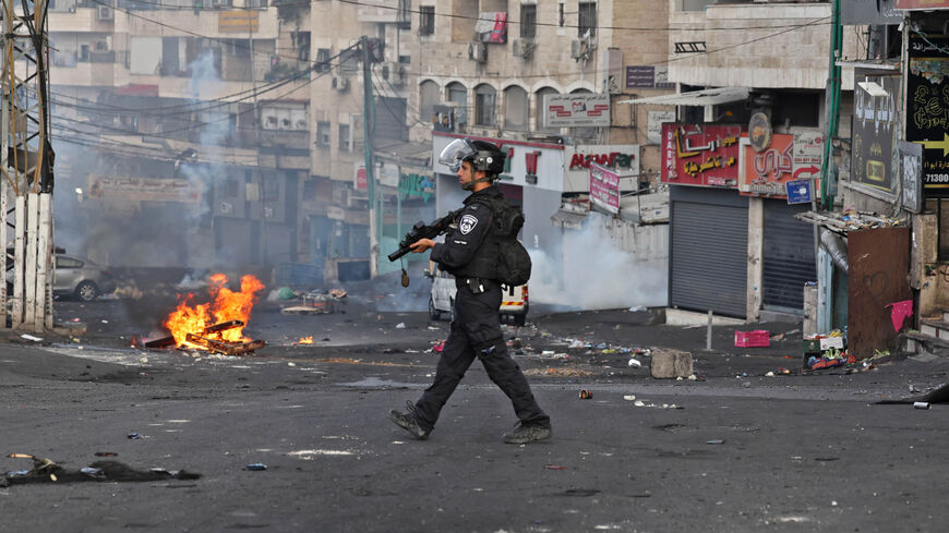 A member of the Israeli security forces is pictured in the Shuafat refugee camp during confrontations with Palestinian protesters, east Jerusalem, Oct. 12, 2022.