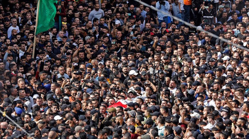 Mourners attend the funeral of Palestinians killed in an overnight Israeli raid, in the occupied West Bank city of Nablus on Oct. 25, 2022. 
