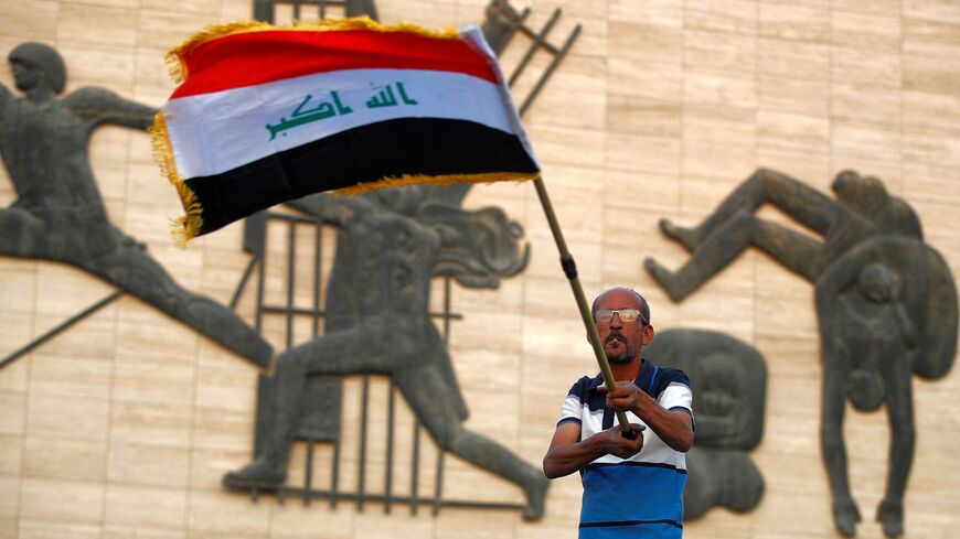 A protester waves an Iraqi national flag in Tahrir Square on Oct. 25, 2022.