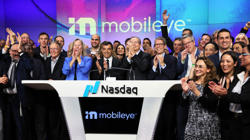 Mobileye Global, Inc. founder and CEO Amnon Shashua and Intel CEO Pat Gelsinger clap.
