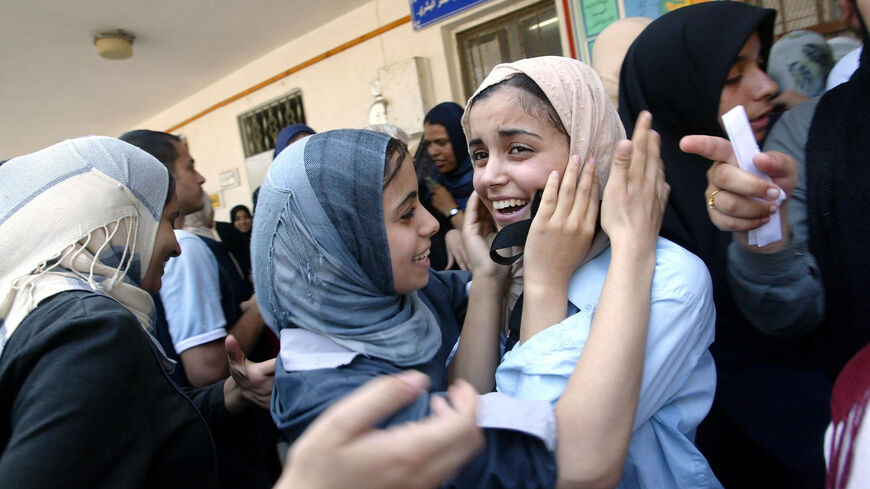 Palestinian students congratulate each other after receiving their test results of those accepted into the Bashir El Rayes women's secondary school, Gaza City, Gaza Strip, July 19, 2003.
