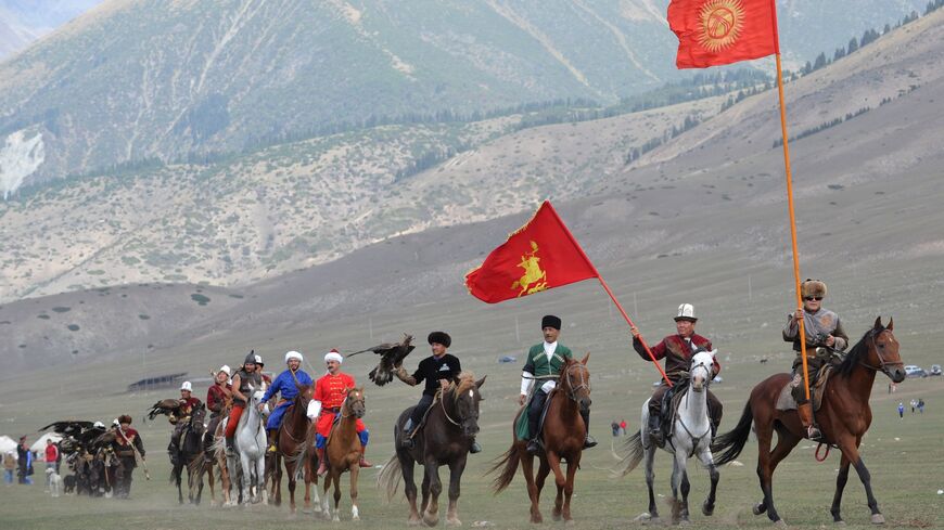 Riders carry flags during the first World Nomad Games