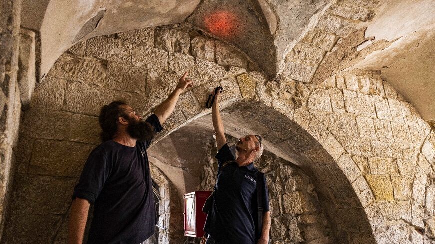 Israeli archaeologists illuminate a carving bearing the name of Adrian von Bubenberg, a Swiss knight who took a pilgramage in 1466 to Jerusalem