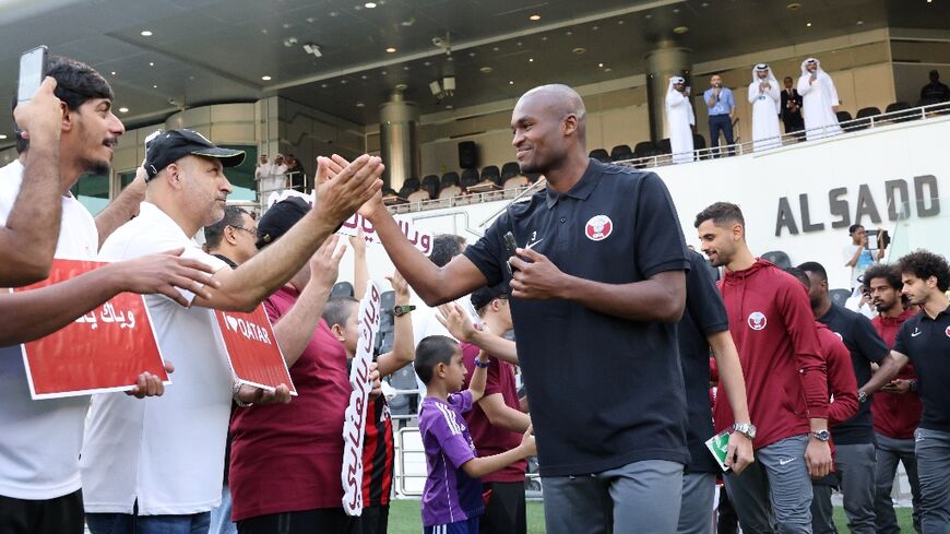 National pride: Qatar defender Abdelkarim Hassan greets fans