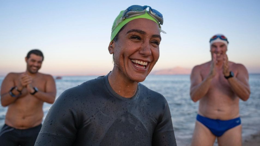 Endurance swimmers Mariam bin Laden (C) and Lewis Pugh (R) following their swim across the Red Sea. The two swam from Saudi Arabia to Egypt to raise awareness of the region's endangered coral reefs.
