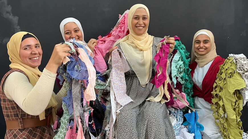 Hadeer Shalaby, the founder of the Green Fashion Initiative, appears with models of green recycled clothing.