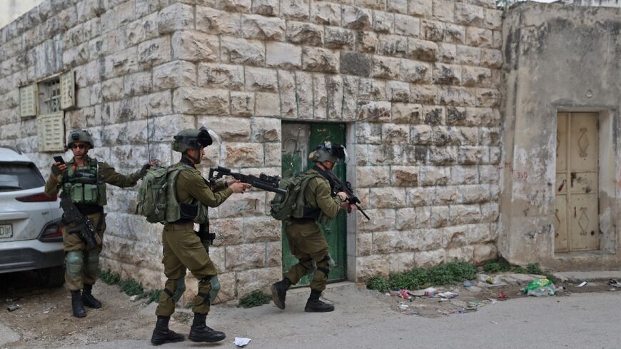 Israeli forces search the Palestinian village of Haris in the occupied West Bank on November 15 following an attack in which a Palestinian killed two Israelis