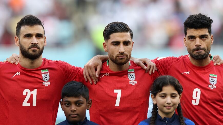 Iran's players, including captain Alireza Jahanbakhsh (C) chose not to sing the national anthem before their opening match