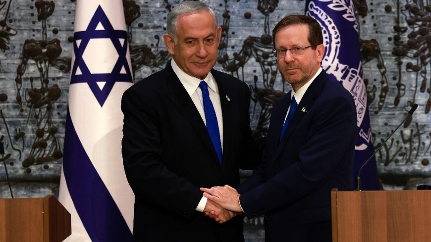 Israeli ex-premier Benjamin Netanyahu, on the left, was mandated with forming a new government by President Isaac Herzog