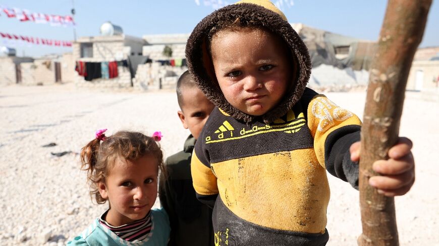 Displaced Syrians are pictured at a newly built housing complex constructed with Turkish support at Mashhad Ruhin,  in the Syrian rebel-held northwestern province of Idlib