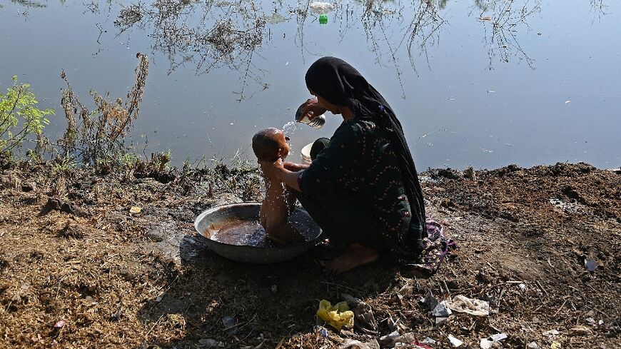 A Pakistani mother and child, who were forced to flee their home amid devastating floods, pictured here in September in Sindh province