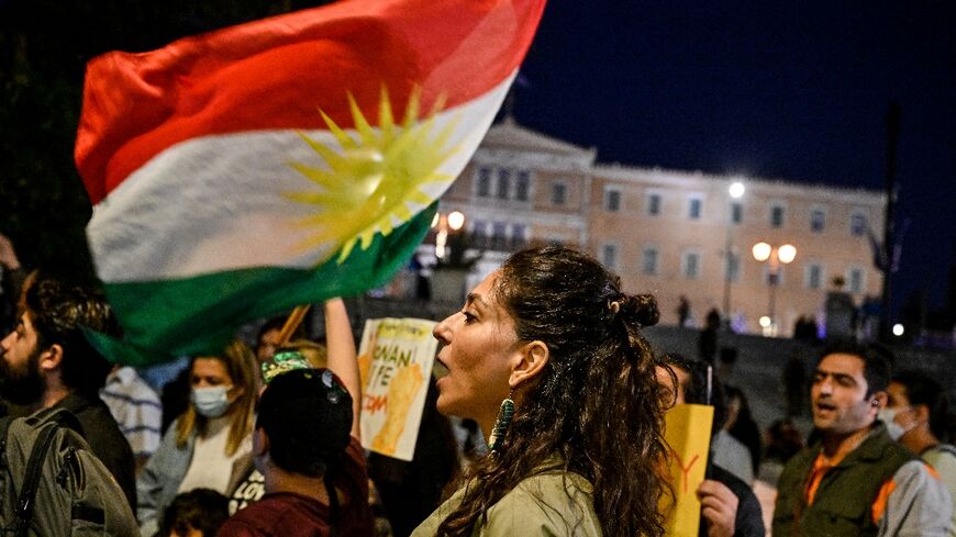 Iranians living in Greece wave a Kurdish flag while singing an Iranian protest song late last month -- one of many such protests worldwide in solidarity with those taking place in the Islamic republic