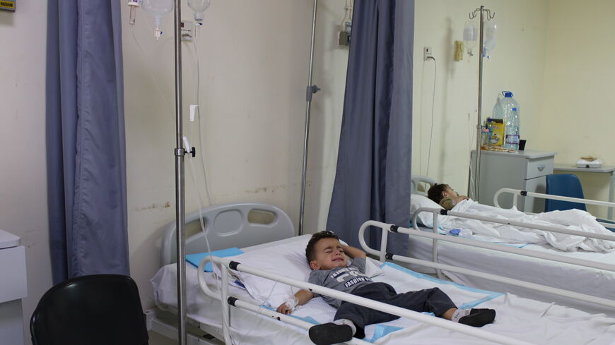Ahmad lies in his hospital bed on his sixth day of treatment at Halba's government hospital in Akkar.