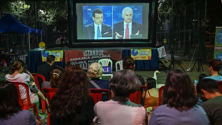 People watch a live broadcast of a televised debate in Istanbul.
