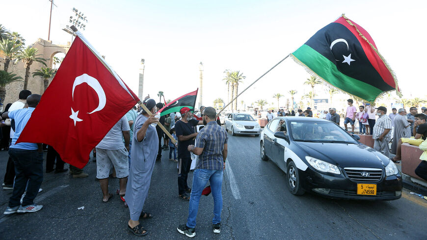 People wave flags of Libya (R) and Turkey (L) during a demonstration in Martyrs' Square, Tripoli, Libya, June 21, 2020.