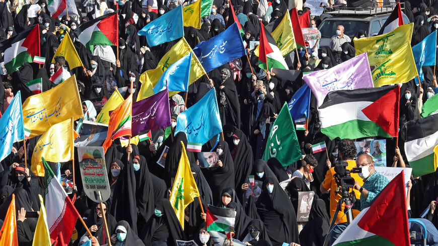 Iranian women wave Palestinian and national flags during a march to condemn the ongoing Israeli airstrikes on the Gaza Strip, Palestine Square, Tehran, Iran, May 19, 2021.