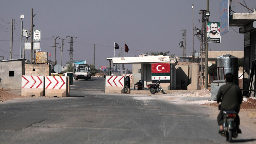 Turkey-backed Syrian fighters man a checkpoint in the town of Marea in the northern Aleppo governorate, facing the Kurdish-controlled area of Tal Rifaat, Syria, Aug. 2, 2022.