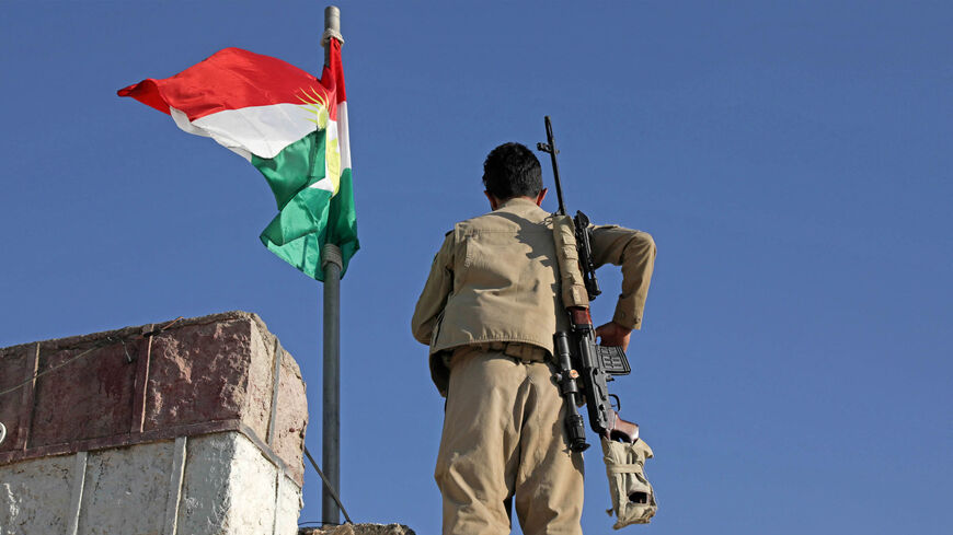 A Kurdish peshmerga fighter affiliated with the Iranian Kurdistan Democratic Party stands guard on top of a building following an Iranian cross-border attack in the town of Koye (Koysinjaq), Iraqi Kurdistan, Oct. 1, 2022.