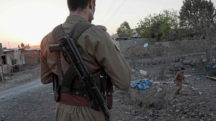 A Kurdish peshmerga fighter affiliated with the Iranian Kurdistan Democratic Party inspects the damage following an Iranian cross-border attack in the town of Koye (Koysinjaq), Iraqi Kurdistan, Oct. 1, 2022.