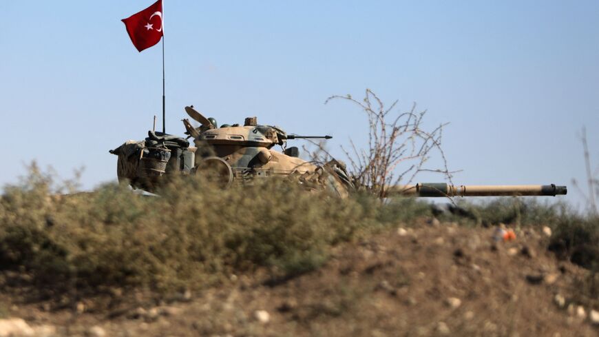 Turkish troops are pictured on the outskirts of the Syrian town of Afrin on October 19, 2022 as the Hayat Tahrir al-Sham (HTS) jihadist group advances towards Syrian opposition-held areas in the northern Syria. - Hayat Tahrir al-Sham, Al-Qaeda's former Syria affiliate, is gaining ground from rival rebels in Syria's Turkish-held north on the heels of some of the deadliest inter-rebel fighting in the region in years.