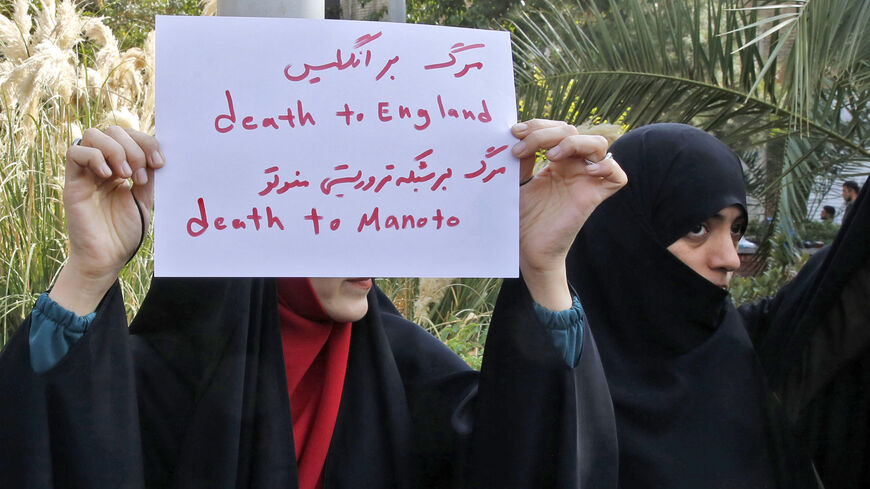 A woman holds up a sign reading in Persian and English "Death to England, Death to Manoto.