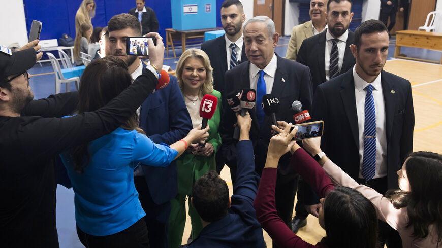 Former Israeli Prime Minister and Likud party leader Benjamin Netanyahu and his wife Sara Netanyahu speak to the press after casting their vote in the Israeli general election, Jerusalem, Nov. 1, 2022.