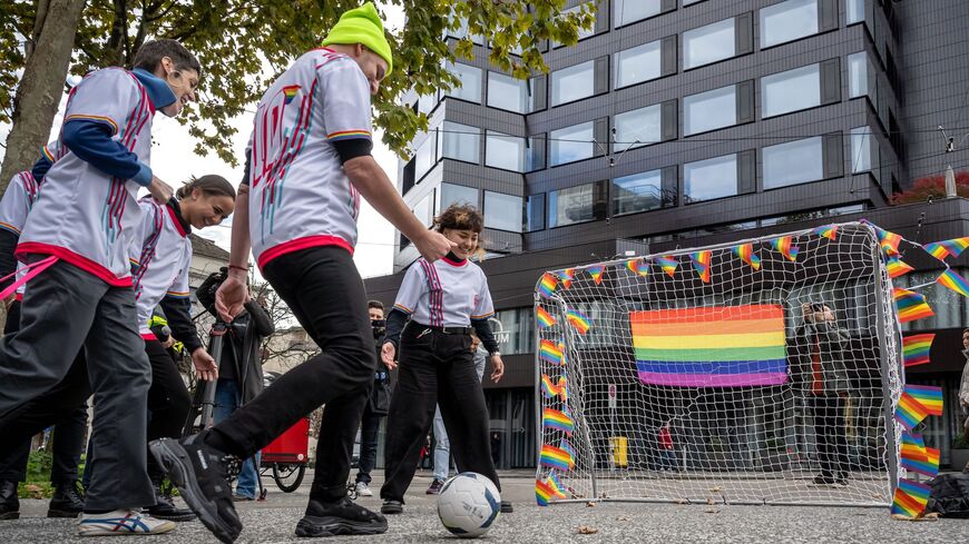 Activists play football during a symbolic action by LGBT+ associations in front of the FIFA museum in Zurich on Nov. 8, 2022.