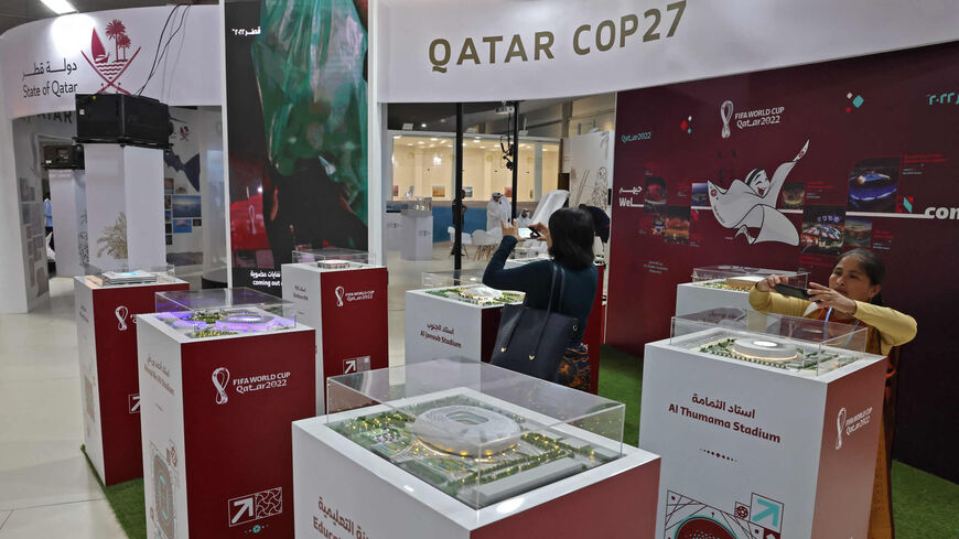 People tour the Qatar COP27 pavillon, displaying the various stadiums that will be hosting the matches of the 2022 World Cup in Qatar, at the Sharm el-Sheikh International Convention Center, Sharm el-Sheikh, Egypt, Nov. 14, 2022.