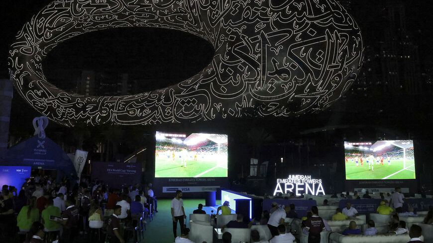 Soccer fans watch a live broadcast of the Qatar 2022 World Cup soccer match between Brazil and Switzerland, near the museum of the Future in Dubai, United Arab Emirates, Nov. 28, 2022.