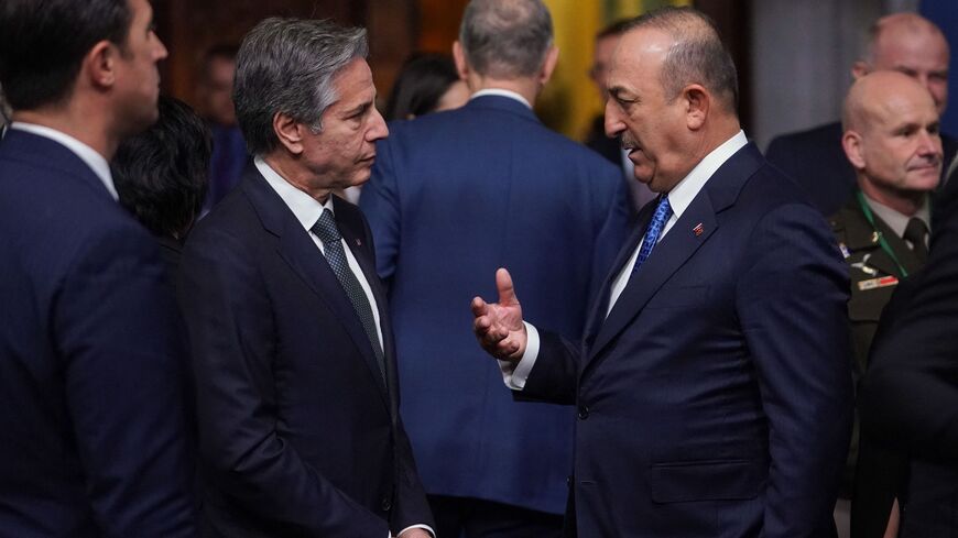 Turkey's Foreign Minister Mevlut Cavusoglu (R) and US Secretary of State Antony Blinken talk.