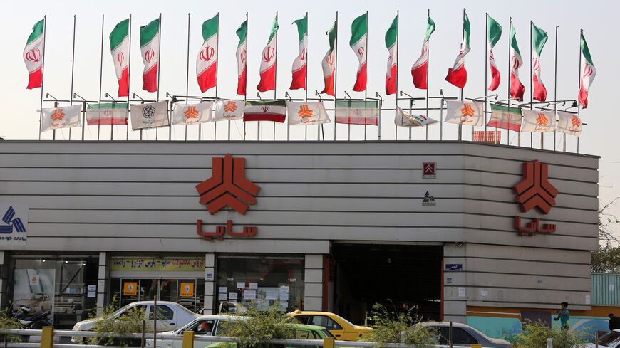 Cars are seen driving past a sales office of Iranian auto manufacturer Saipa group, Tehran, Iran, Sept. 12, 2015.