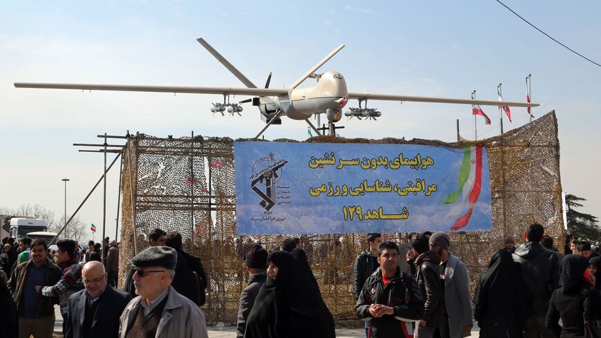 Iranians walk past Iran's Shahed 129 drone displayed during celebrations in Tehran to mark the 37th anniversary of the Islamic revolution on Feb. 11, 2016. 