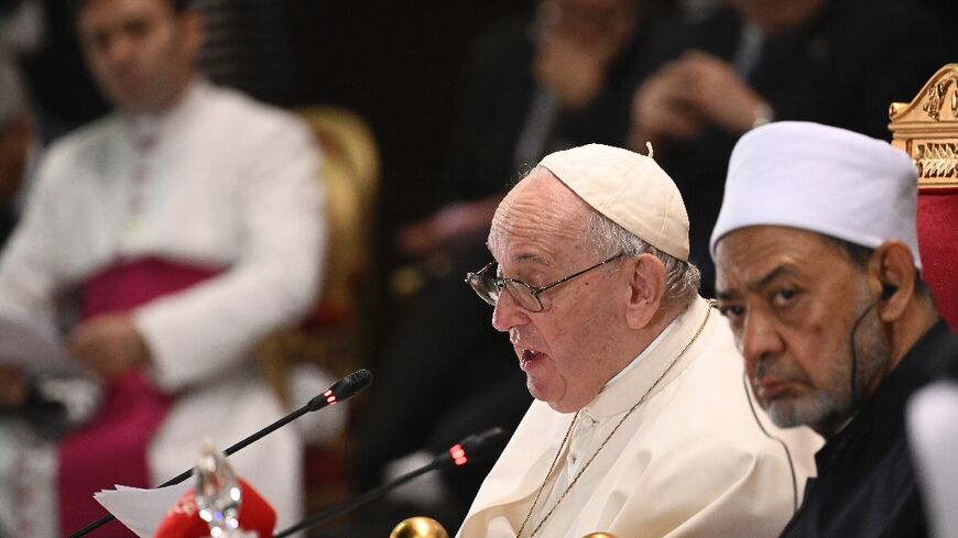 Pope Francis (L) speaks during a meeting with members of the Muslim Council of Elders, alongside the Grand Imam of al-Azhar mosque Sheikh Ahmed Al-Tayeb, in the mosque courtyard of Sakhir Royal Palace in Bahrain's Sakhir city on Friday