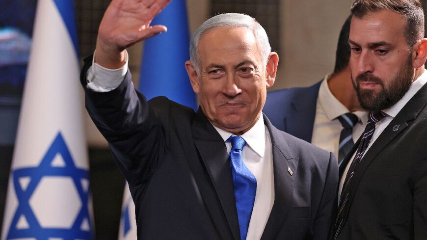 Former Israeli prime minister Benjamin Netanyahu greets right-wing supporters at campaign headquarters in Jerusalem as he scents victory in his bid for a political comeback