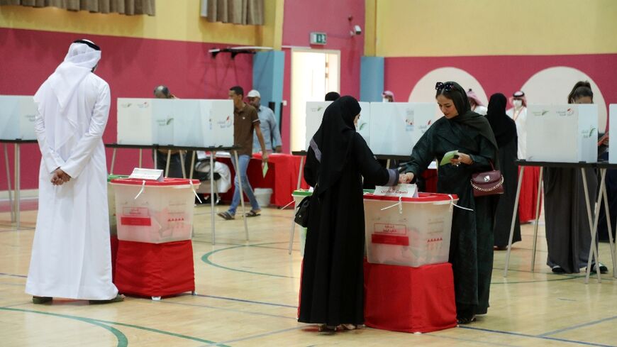 A Bahraini woman casts her ballot at a polling station in the city of Jidhafs, about 3km west of the capital Manama, during parliamentary elections on Saturday