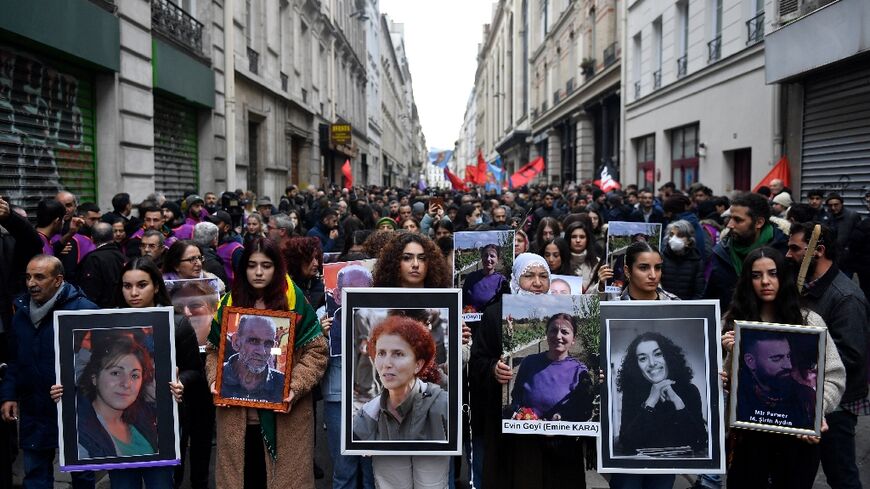 Several hundred people marched in Paris on Monday to remember the shooting victims. 